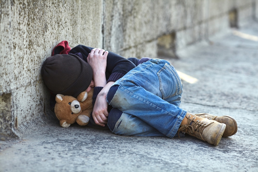 homeless child sleeping on the street